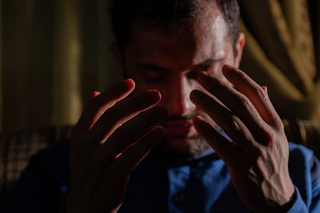 muslim male rising his hands to pray for allah and asking for forgiveness and helpの写真素材