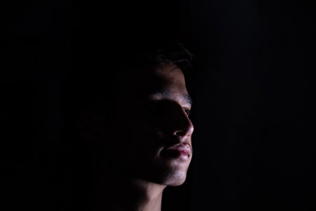 Portrait for teenager in dark and light studioの写真素材