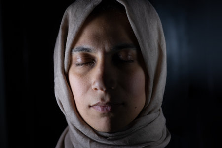 portrait for muslim women on black background in studio with facial expressionsの写真素材