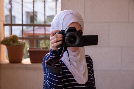 muslim woman holding the cameraの写真素材