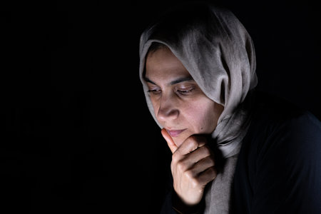 portrait for muslim women on black background in studio with facial expressionsの写真素材