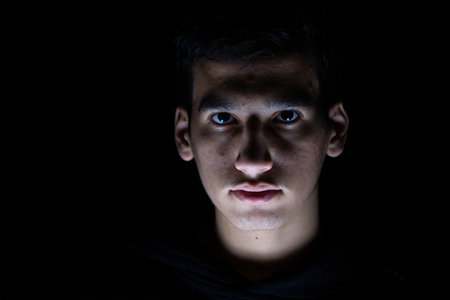 Portrait for teenager in dark and light studioの写真素材