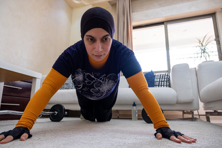 muslim woman doing exercises in home