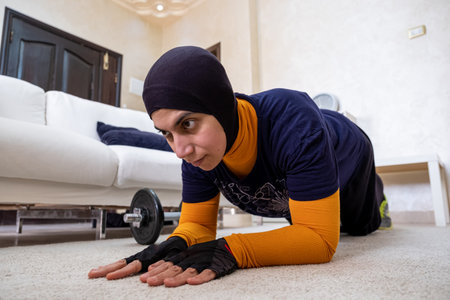 muslim woman doing exercises in homeの写真素材