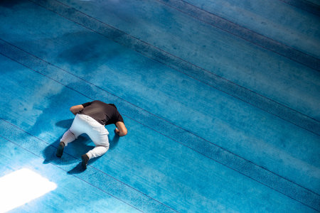 Top view of adults praying inside masjid and Prostration in prayerの写真素材