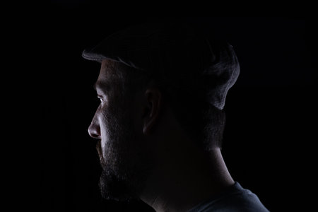 Man wearing glasses on black background with face expressionsの写真素材