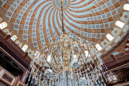 Golden chandelier in muslims mosque used to light and decorate the mosque and domeの写真素材