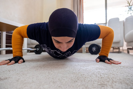 muslim woman doing exercises in homeの写真素材
