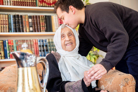 Arabic family enjoy eid celebration with grandmother while laughing togetherの写真素材