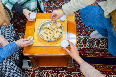 hands holding eid sweets and coffee cups, multigenerational family