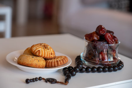 Variety of semolina maamoul cookies displayed with crescent ,star and Ramadan decorations. Traditional Arabic sweets for Eid al Adha and Eid al Fitr celebrations.の写真素材