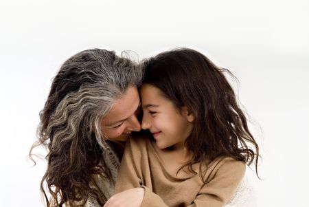 mother and daughter embracing and looking at each otherの写真素材