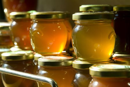 many honey jars on a shelf in a warehouse