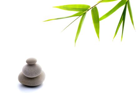 bamboo leavs and three stones isolated on whiteの写真素材