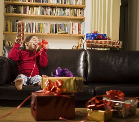 a little girl happy after reciving a presentの写真素材