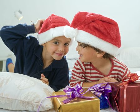 two boys with christmas hat and presentsの写真素材