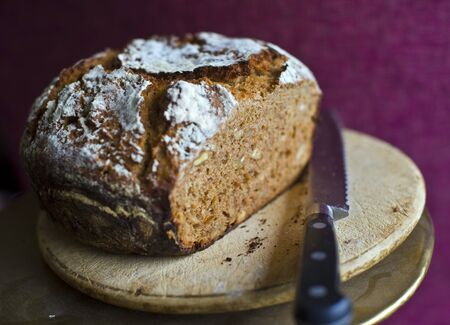 fresh loaf of sliced wholsome home made bread in shallow depth of field