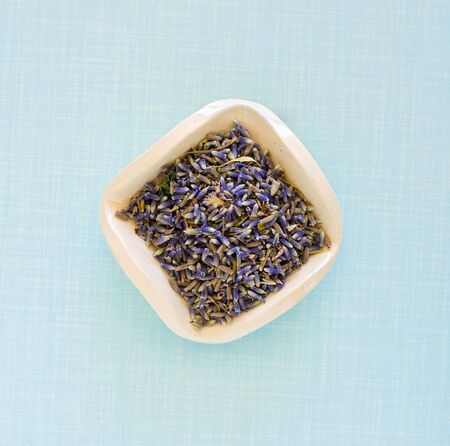 dry lavender flowers in a square ceramic plateの写真素材