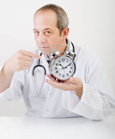 doctor pointing at alarmclockの写真素材