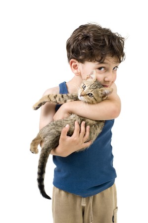 young boy holding and kissing a kittenの写真素材