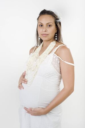 pregnant woman in a retro white dress and necklaceの写真素材