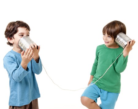 Two boys talking on a tin can phone isolated on whiteの写真素材