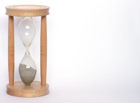 Wooden hourglass over white background