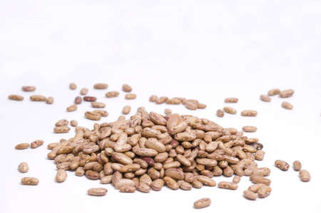large pile of pinto beans isolated on whiteの写真素材