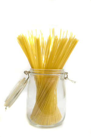 glass jar full of spaghetti, isolated on white, copy spaceの写真素材