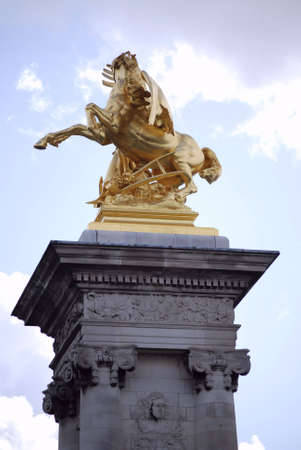 golden statue in paris, on one of the famous bridgesの写真素材