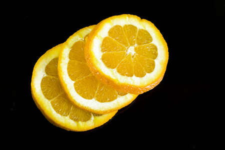orange slices on black backgroundの写真素材