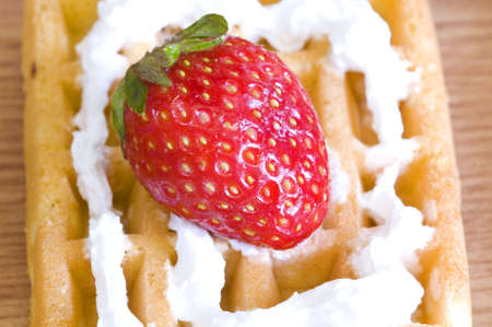 closeup on strawberry and whip cream waffleの写真素材
