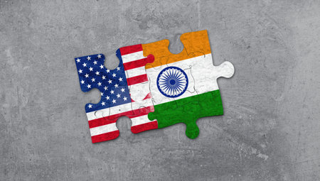 United States of America and India Flags in puzzle isolated on concrete backgroundの素材
