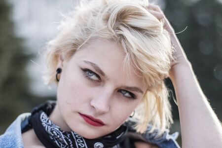 Beautiful serious young girl portrait in the streetの写真素材