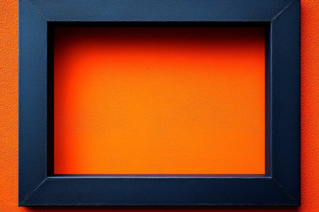 A dark blue square frame is set against a bright orange textured wall creating a strong visual contrast.の素材