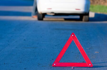 Car accident on a road. Focus is on the red triangle signの写真素材