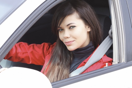 Pretty brunette driving a white car