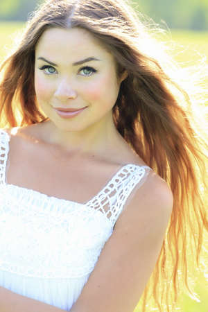 Portrait of the young beautiful smiling woman outdoors の写真素材