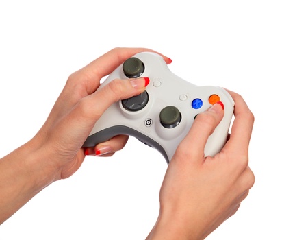 Female hands with a gamepad. Isolated on white background