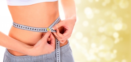 Woman taking measurements of her body on blurry background with copyspace