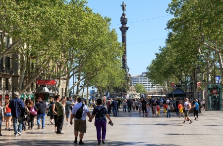 BARCELONA - APRIL 17, 2013  People walk by at the famous La Rambla on April 17, 2013 in Barcelona,...