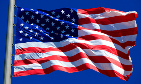 Flag of the USA against a blue sky