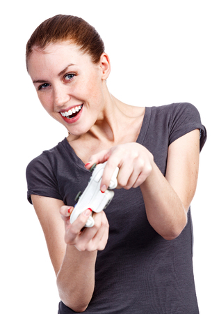 Young woman plays a videogame, isolated on white background