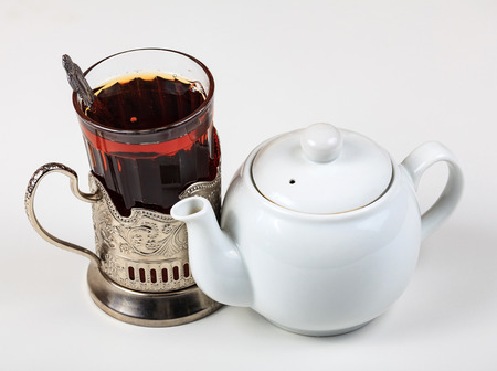 Closeup shot of teapot and glass on white backgroundの写真素材