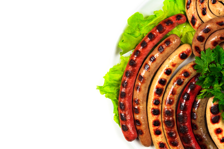 Closeup shot of a dish full of grilled sausages, isolated on white background. Flat layの写真素材