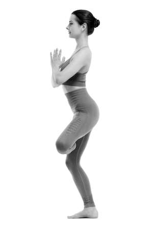 Fitness woman doing yoga exercise. Isolated on white backgroundの写真素材