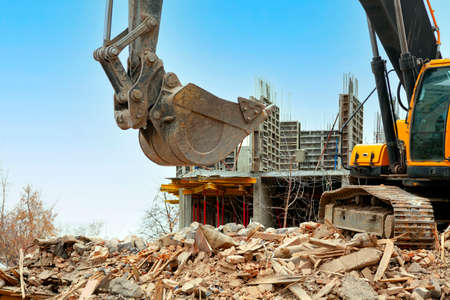 Demolition of an old building by modern excavator