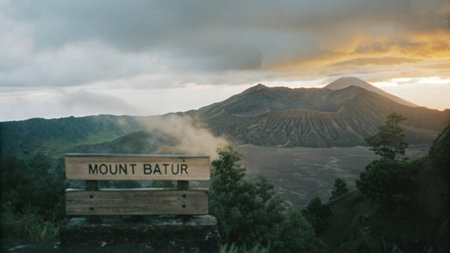 Mount Batur, a volcano in Bali, Indonesia, shrouded in mist, with rugged slopes and a plume of steam, offering a dramatic and beautiful natural landscape.の素材