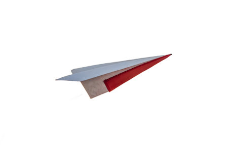 Discover a captivating red and white paper airplane soaring gracefully through the air. This whimsical image evokes childhood memories, imagination, and the joy of flight. Perfect for projects about dreams, freedom, or simple papercraft art.の素材