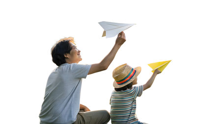 A heartwarming scene unfolds as a mother and her child enjoy a creative playtime, decorating a wall with colorful paper airplanes. This tender moment captures family bonding, joy, and the simple fun of crafting together indoors.の素材